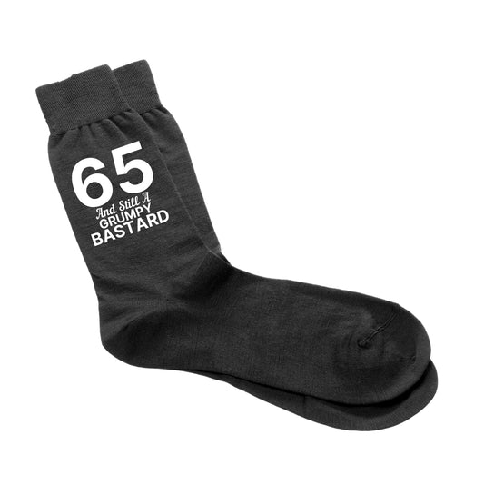 Funny 65th birthday socks for men with the phrase ‘65 And Still A Grumpy Bastard.’”
Cheeky milestone birthday socks, size 6-12, perfect for a 65th birthday gift.
